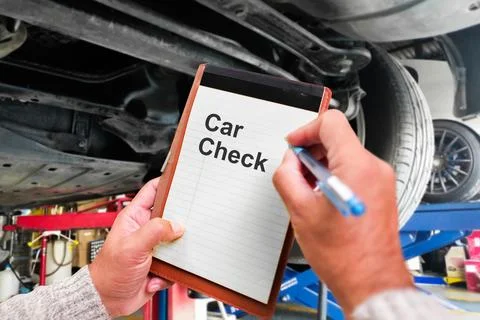  Auto mechanic taking note to notebook for check car mileage Stock Photos