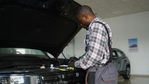 Auto mechanic taking notes during vehicle inspection Stock Footage 300611588