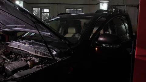 Auto mechanic trying to start car during repairing Stock Footage 123506446