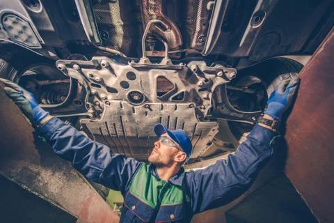 Auto mechanic under the car Stock Photos