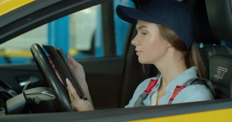 Auto mechanic uses tablet computer to inspect technical condition sitting behind 스톡 동영상 141532321