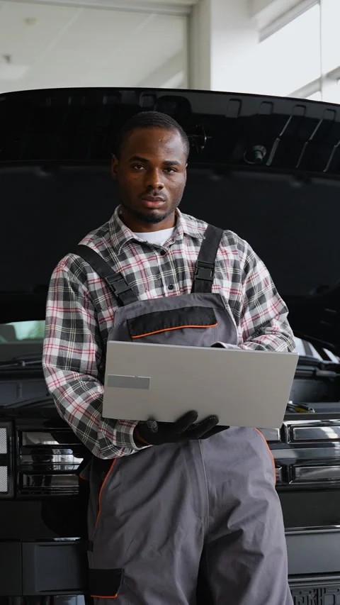Auto mechanic using laptop for engine diagnostics in workshop Stock Footage 300614607