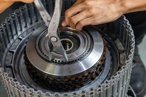 Auto mechanic using snap ring pliers to assemble automatic transmission clu.. Stock Photos