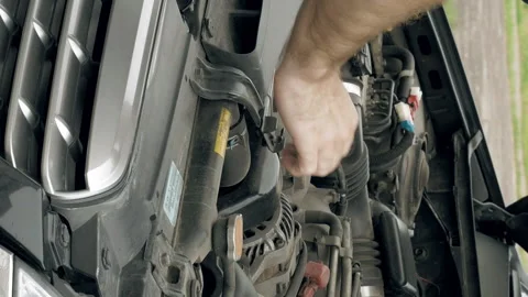 Auto mechanic visually examines car motor engine Stock Footage 91179100