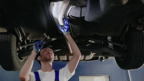 Auto mechanic is walking to check the condition of the car Stock Footage 204925085