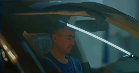 Auto mechanic who uses a computer diagnostic program during the repair of a car Stock Footage 224014832