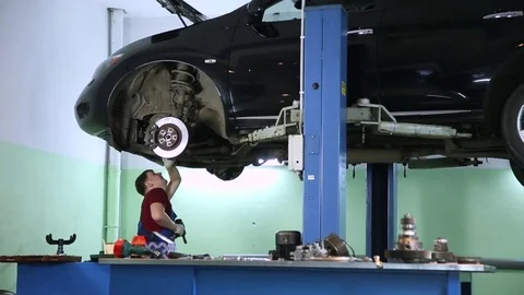 Auto mechanic at work in the garage Stock Footage 70394067