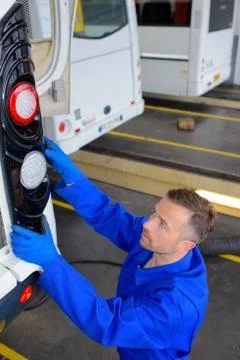 An auto mechanic worker fixing a bus Stock Photos
