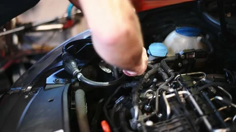 Auto mechanic working on car connecting bleeding tool to fuel. Auto repair shop Video stock 141340351