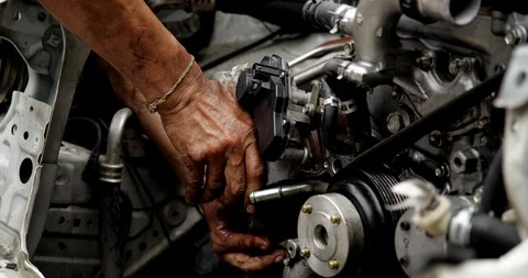 Auto mechanic working on car engine in mechanics garage Stock Footage 114538544