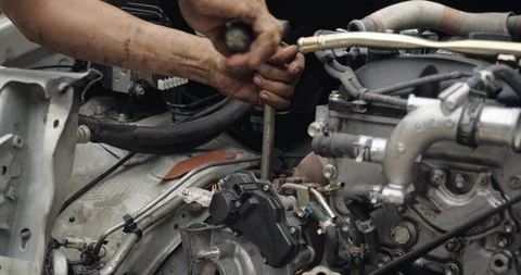 Auto mechanic working on car engine in mechanics garage Stock Footage 114538899