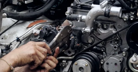 Auto mechanic working on car engine in mechanics garage Stock Footage 114539384