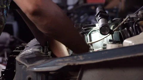 Auto mechanic working on car engine in mechanics garage. close-up shot 動画素材 117126650