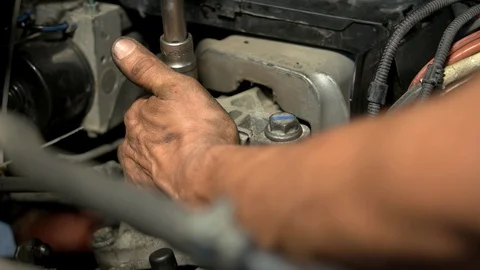 Auto mechanic working on car engine in mechanics garage. Video stock 130070255