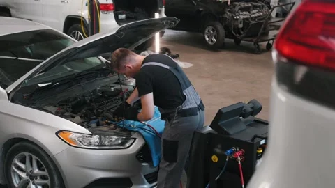 Auto mechanic working on car engine in mechanics garage. Repair service Stock Footage 299725243