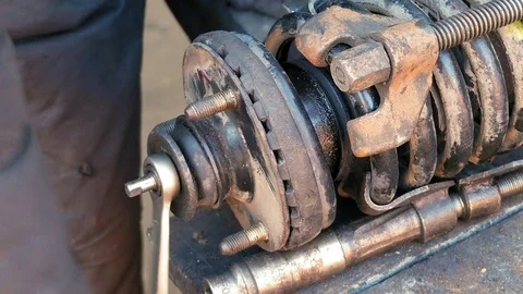 Auto mechanic working on shock absorber in garage Stock Footage 69967808