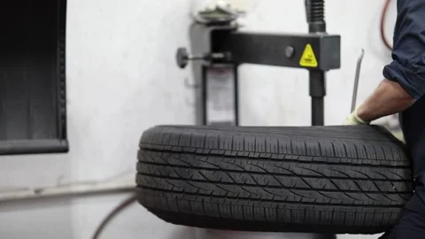 Auto Mechanic Working on Tire Stock Footage 244364973