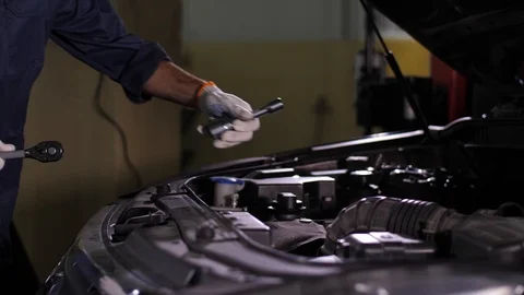 Auto mechanic working with wrench under car hood 스톡 동영상 123506030