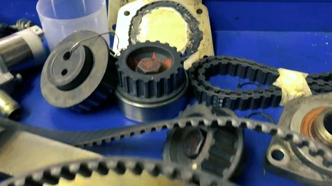 Auto mechanic workshop table. workshop spare parts. belt and crankshaft Stock Footage 101706651