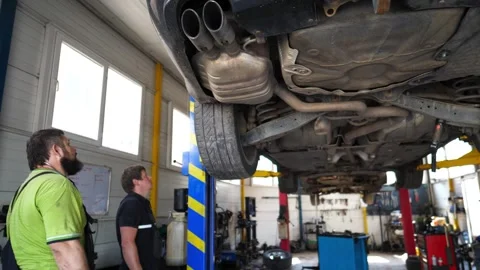 Auto mechanics doing technical inspection and diagnostic of vehicle at garage Stock Footage 295333530