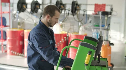 Auto Mechanics Performing Vehicle Diagnostics on Computer Stock Footage 299127338