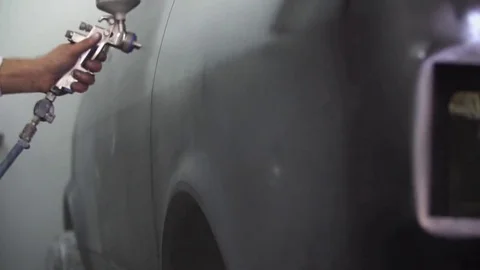 Auto painter spraying paint on car in special booth Stock Footage 85367336
