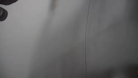 Auto painter spraying paint on car in special booth Stock Footage 85369134