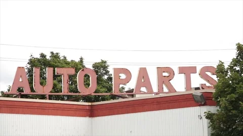 Auto parts words caption text sign letters protruding from top of building Video stock 248714970