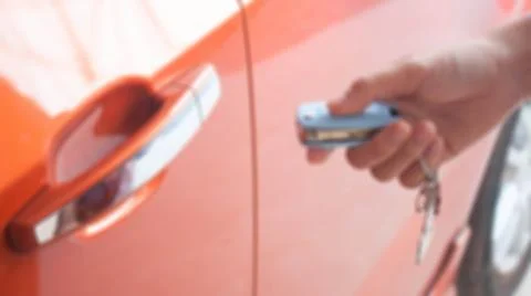 Auto remote key pressed by the finger. Stock Photos