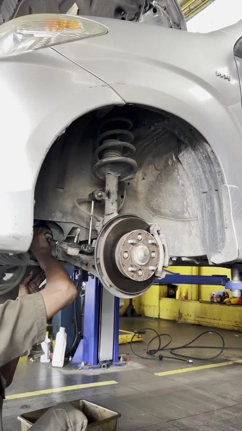 Auto Repair Workshop Mechanic Working on Vehicle Maintenance Process Stock Footage 332453604