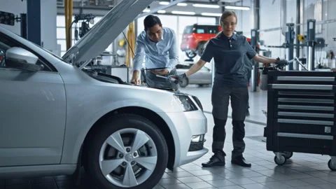 Auto Report Shop Woman Fixes Car Stock Footage 321005372