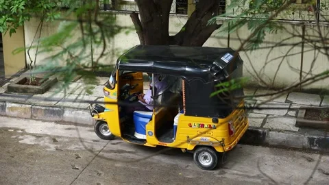Auto-rickshaw-driver-checkig-mobile-phone Stock Footage 137839504