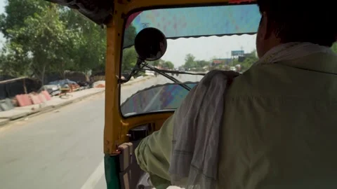 Auto rickshaw driver on sunny road seen from inside tuk tuk Stock Footage 333380579