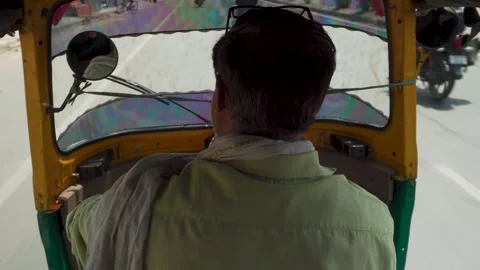 Auto rickshaw driver on sunny road seen from inside tuk tuk Stock Footage 333380637