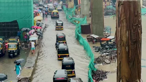 Auto rickshaw into a puddle of water splashing around. 4K Stock Footage 247169562