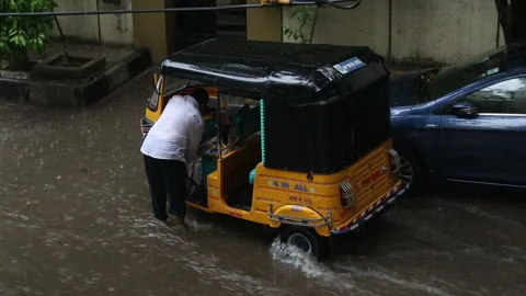 Auto-rickshaw-stuck-in-rainwater Stock Footage 137368620