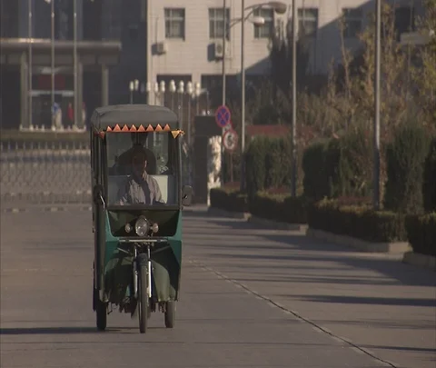 Auto rickshaw taxi approaches camera and passes by. Stock Footage 86745793