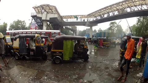 Auto rickshaw waiting for customers raining day with pedestrian walking Stock Footage 197003716