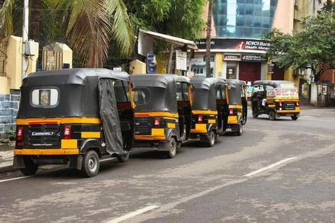 Auto rickshaws standing in queue on road, Pune, Maharashtra, India Auto ri... Stock Photos
