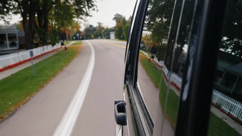 Auto rides in a typical suburban US city, the road and houses are reflected on Stock Footage 125616329