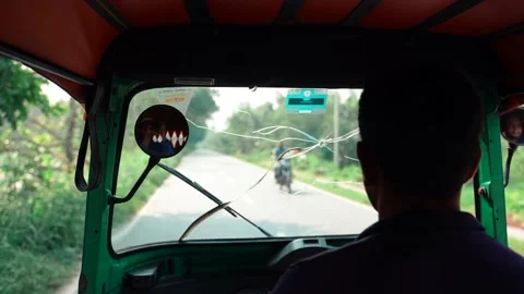 An auto rikshaw driver driving his vehicle in the road Stock Footage 164512424