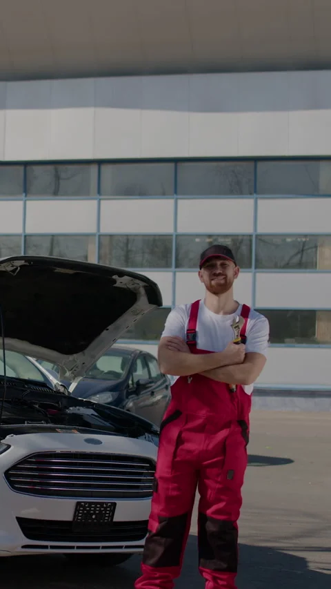 Auto service center backdrop of broken-down car and bustling ambiance of auto Stock Footage 272158444