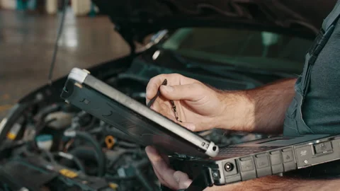 Auto service, maintenance concept. Close up of hands car electrician repairs car Stock Footage 180927942