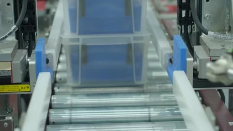 Auto system moving plastic storage bins through modern factory line. Stock Footage 324753593
