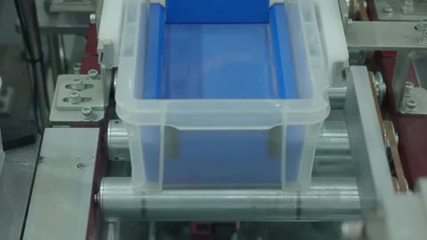 Auto system moving plastic storage bins through modern factory line. Stock Footage 324753601