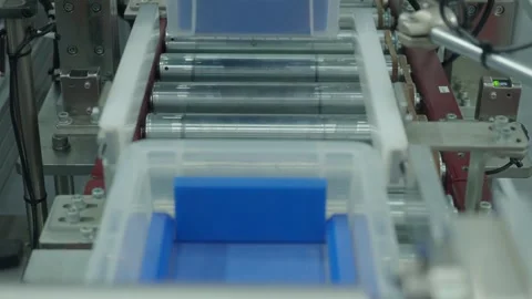Auto system moving plastic storage bins through modern factory line. Stock Footage 324753624