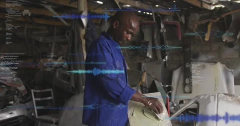 Auto tech placing panel on stand sanding greenfiller for fix with blue overlay Stock Footage 329785114