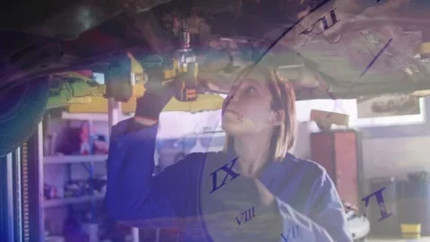 Auto tech using yellow drill under car torquing bolt to align, clock numerals Stock Footage 328307089