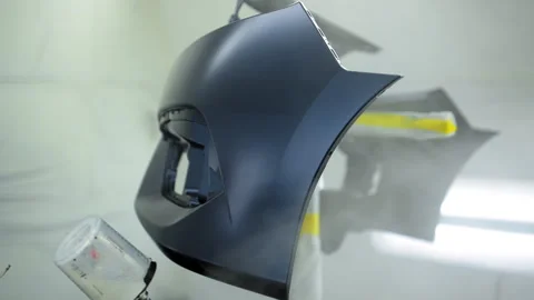 Auto technician spray lacquer on car bumper inside clean, ventilated paint booth Stock-Footage 321517035