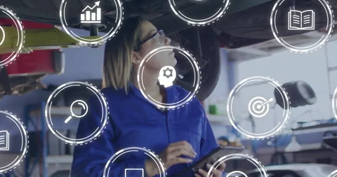 Auto technician tilting head under lifted car and tapping tablet as diagnostic Stock Footage 310316825